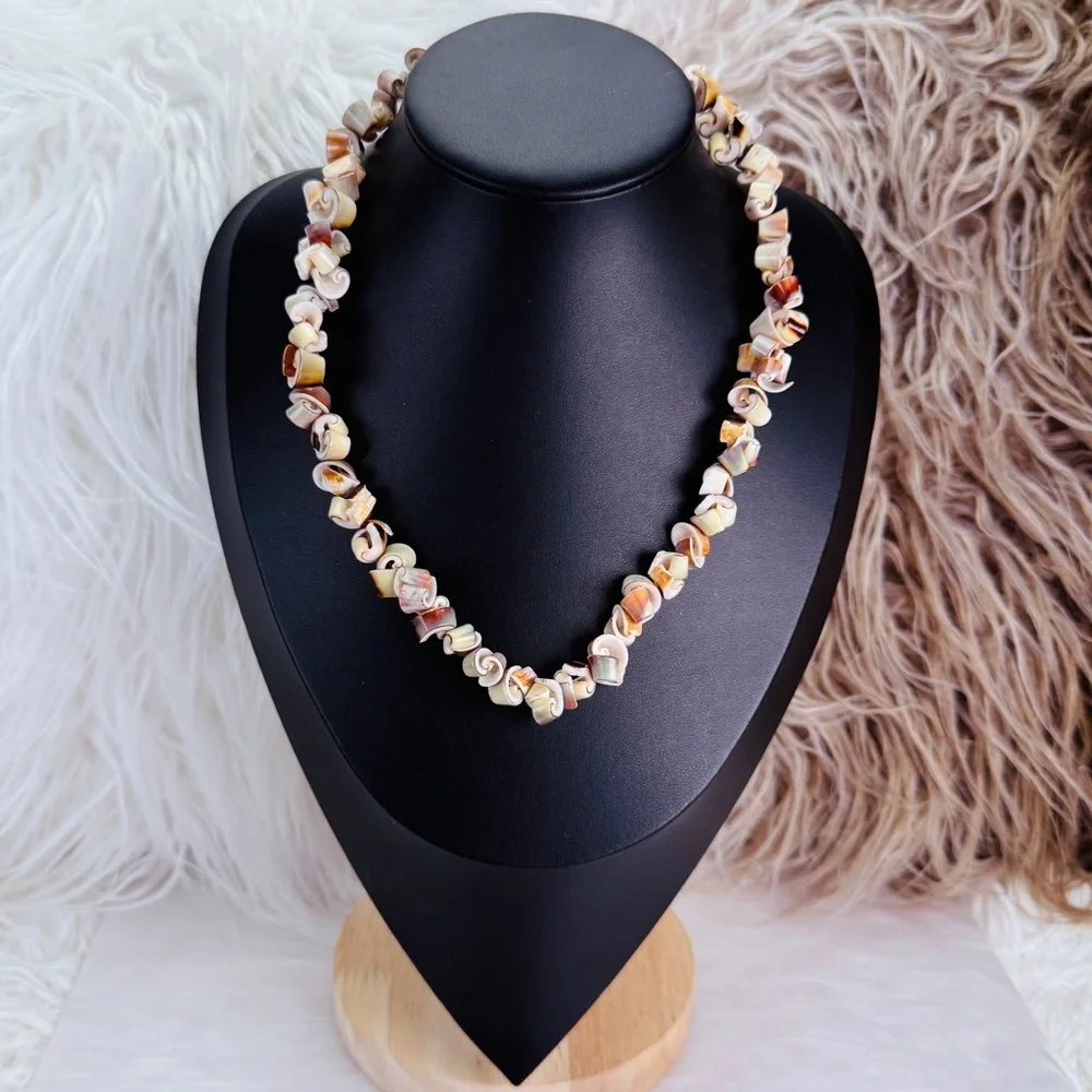 Beautiful vintage necklace composed of curly-cut conch shell beads individually